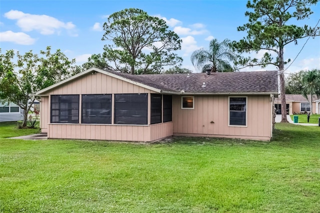 281 NE Greenbrier Ave, Port St Lucie, FL 34983 - back of house featuring a sunroom, a lawn, and roof with shingles