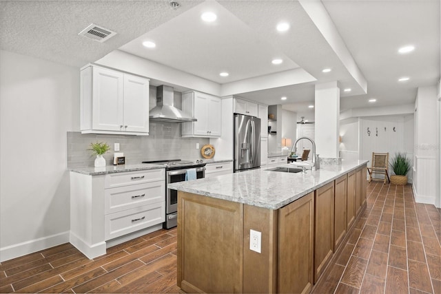 4621 S Atlantic Ave Unit 7202, Port Orange, FL 32127 - kitchen with wall chimney range hood, appliances with stainless steel finishes, wood finish floors, backsplash, and a sink
