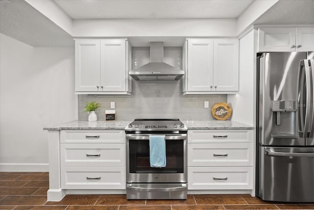 4621 S Atlantic Ave Unit 7202, Port Orange, FL 32127 - kitchen featuring appliances with stainless steel finishes, wall chimney range hood, backsplash, and white cabinets