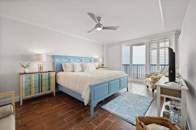 4621 S Atlantic Ave Unit 7202, Port Orange, FL 32127 - bedroom featuring access to outside, dark wood-type flooring, a textured ceiling, a ceiling fan, and ornamental molding