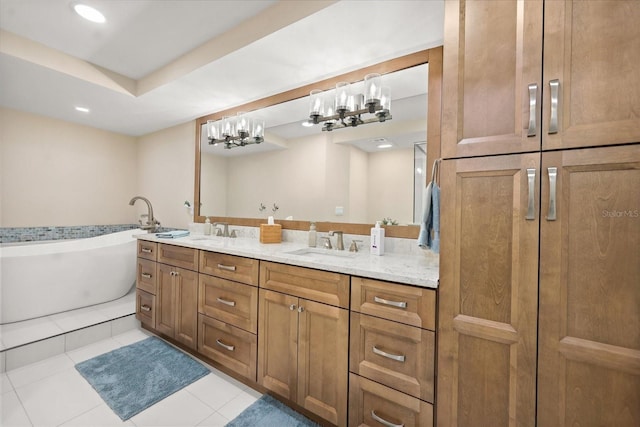 4621 S Atlantic Ave Unit 7202, Port Orange, FL 32127 - bathroom with double vanity, a freestanding bath, tile patterned flooring, recessed lighting, and a chandelier