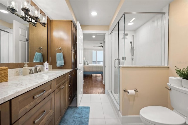 4621 S Atlantic Ave Unit 7202, Port Orange, FL 32127 - bathroom with vanity, toilet, connected bathroom, a stall shower, and ceiling fan