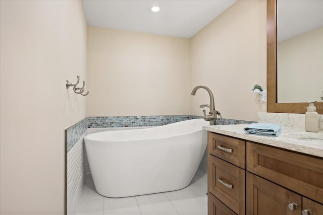 4621 S Atlantic Ave Unit 7202, Port Orange, FL 32127 - full bathroom with tile patterned flooring, vanity, a freestanding tub, and tile walls