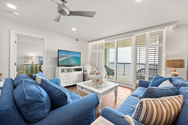 4621 S Atlantic Ave Unit 7202, Port Orange, FL 32127 - living room featuring wood finished floors, a ceiling fan, a textured ceiling, and recessed lighting