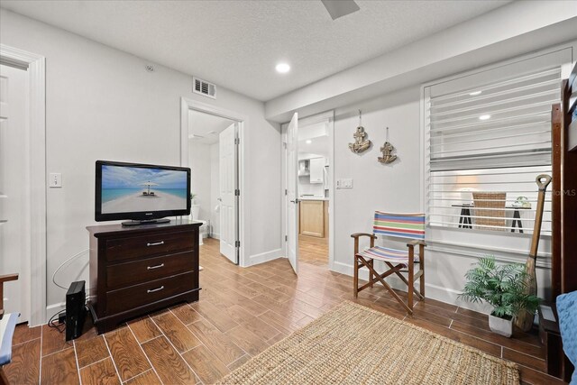 4621 S Atlantic Ave Unit 7202, Port Orange, FL 32127 - living area with wood finished floors, recessed lighting, baseboards, and a textured ceiling