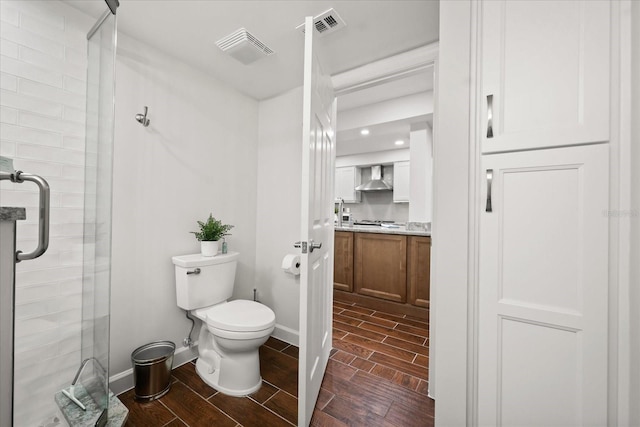 4621 S Atlantic Ave Unit 7202, Port Orange, FL 32127 - full bath with wood tiled floors, a stall shower, toilet, and vanity
