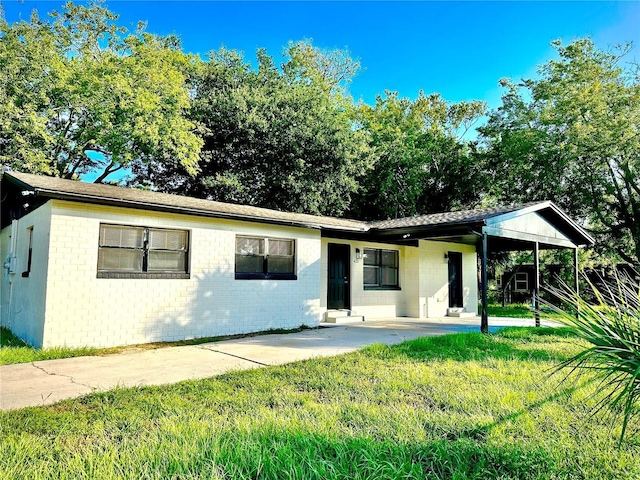 425 Walnut St, Daytona Beach, FL 32114 - view of front of home with a front lawn, a patio area, and brick siding
