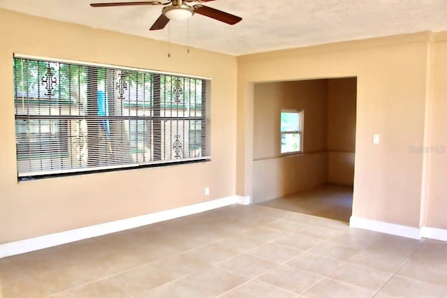 425 Walnut St, Daytona Beach, FL 32114 - spare room featuring a ceiling fan, baseboards, and light tile patterned floors