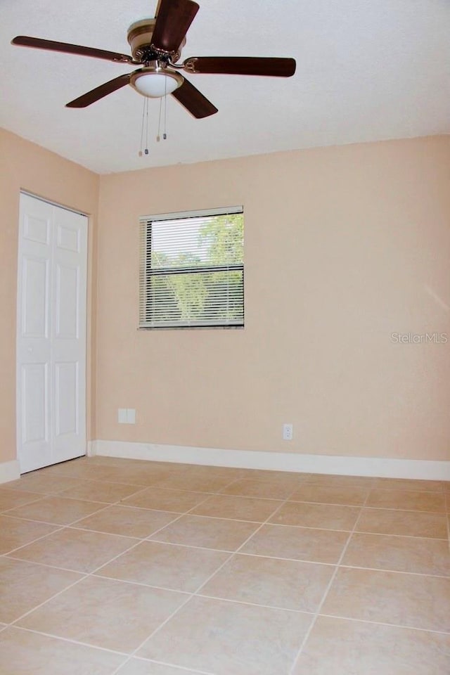 425 Walnut St, Daytona Beach, FL 32114 - spare room featuring light tile patterned floors, a ceiling fan, and baseboards