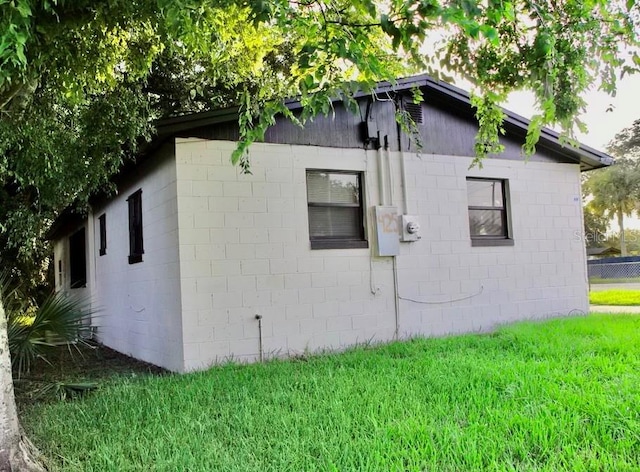 425 Walnut St, Daytona Beach, FL 32114 - view of property exterior featuring concrete block siding and a lawn