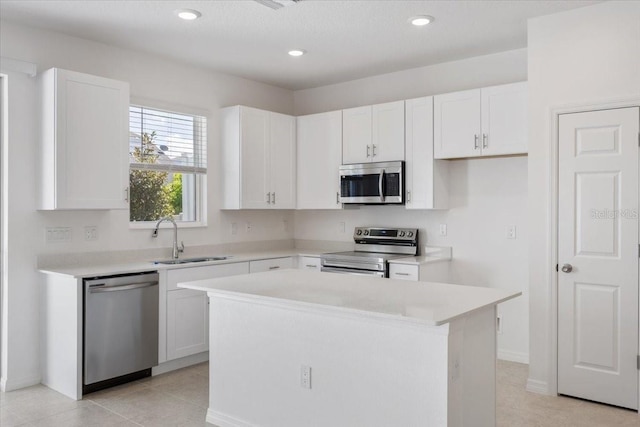 1267 Stockwell Ave, Saint Cloud, FL 34771 - kitchen featuring stainless steel appliances, a kitchen island, white cabinetry, light countertops, and recessed lighting