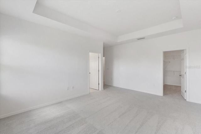 1267 Stockwell Ave, Saint Cloud, FL 34771 - empty room featuring a tray ceiling and light carpet