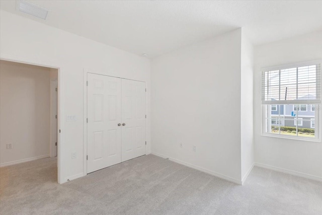 1267 Stockwell Ave, Saint Cloud, FL 34771 - unfurnished bedroom featuring light colored carpet and a closet