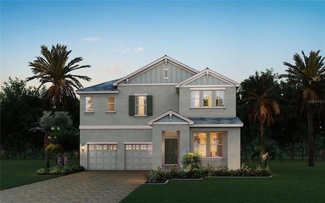 11027 Hollow Bay Dr, Winter Garden, FL 34787 - view of front of home with an attached garage, decorative driveway, a yard, and stucco siding