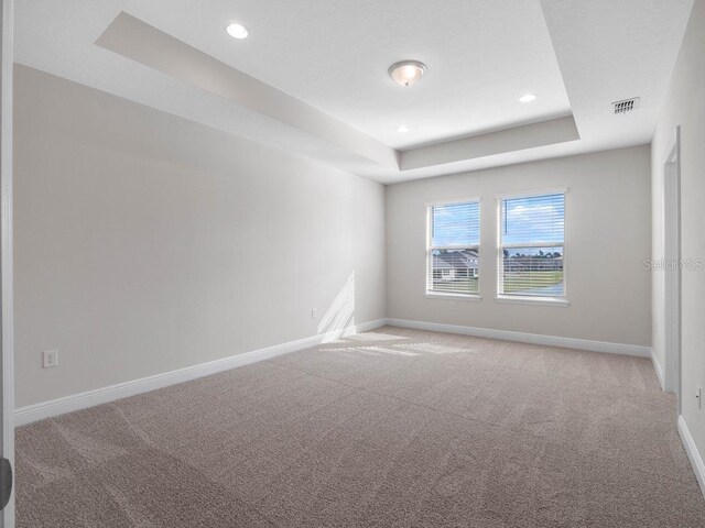 11027 Hollow Bay Dr, Winter Garden, FL 34787 - carpeted spare room featuring a tray ceiling, baseboards, and recessed lighting