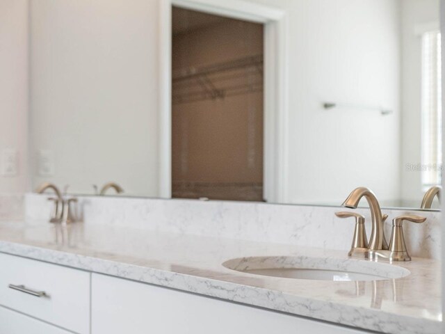 11027 Hollow Bay Dr, Winter Garden, FL 34787 - bathroom with double vanity and decorative backsplash