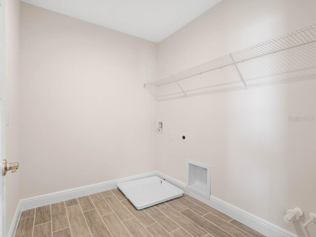 11027 Hollow Bay Dr, Winter Garden, FL 34787 - washroom with hookup for an electric dryer, wood tiled floors, baseboards, and gas dryer hookup