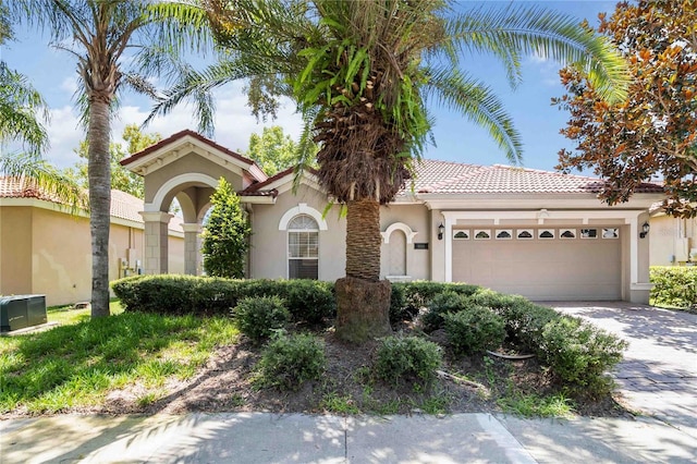 11322 Rapallo Ln, Windermere, FL 34786 - mediterranean / spanish house with stucco siding, a garage, driveway, and a tiled roof
