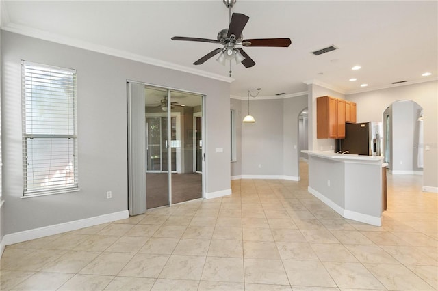 11322 Rapallo Ln, Windermere, FL 34786 - kitchen with arched walkways, stainless steel fridge, ceiling fan, ornamental molding, and recessed lighting