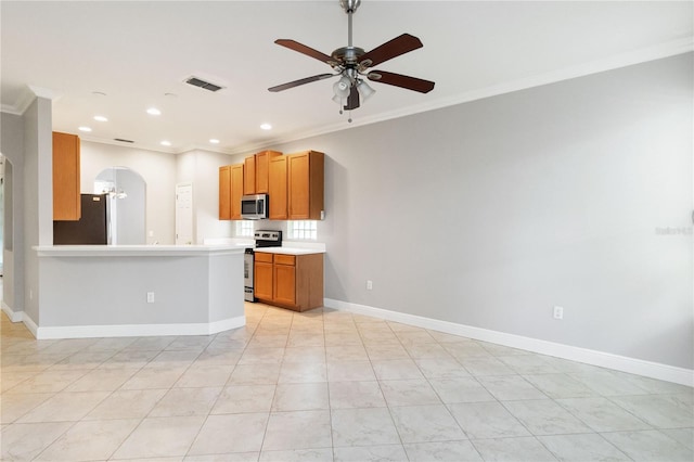 11322 Rapallo Ln, Windermere, FL 34786 - kitchen with stainless steel appliances, arched walkways, ornamental molding, a ceiling fan, and light countertops