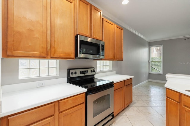 11322 Rapallo Ln, Windermere, FL 34786 - kitchen featuring appliances with stainless steel finishes, crown molding, light countertops, and healthy amount of natural light