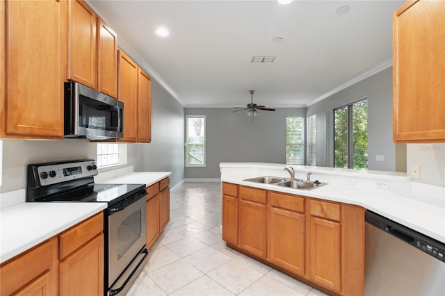11322 Rapallo Ln, Windermere, FL 34786 - kitchen with stainless steel appliances, ornamental molding, a peninsula, light countertops, and plenty of natural light