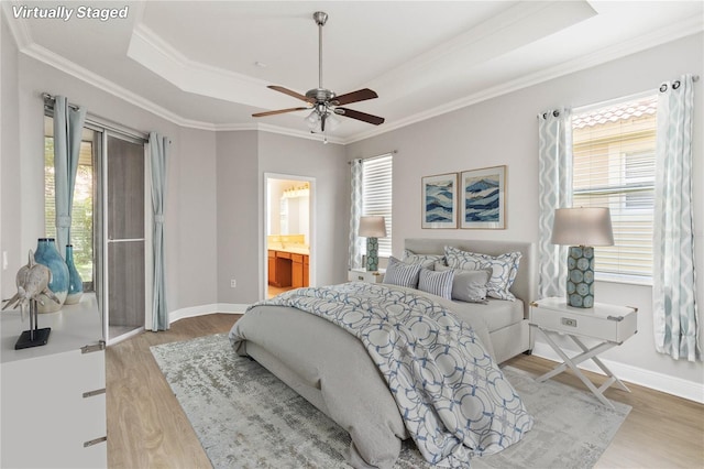 11322 Rapallo Ln, Windermere, FL 34786 - bedroom featuring a tray ceiling, wood finished floors, multiple windows, and crown molding