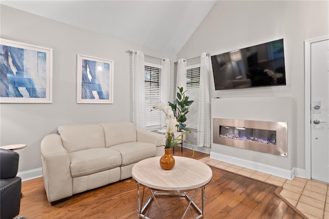938 Southridge Trl, Altamonte Springs, FL 32714 - living area with a glass covered fireplace, wood finished floors, baseboards, and high vaulted ceiling