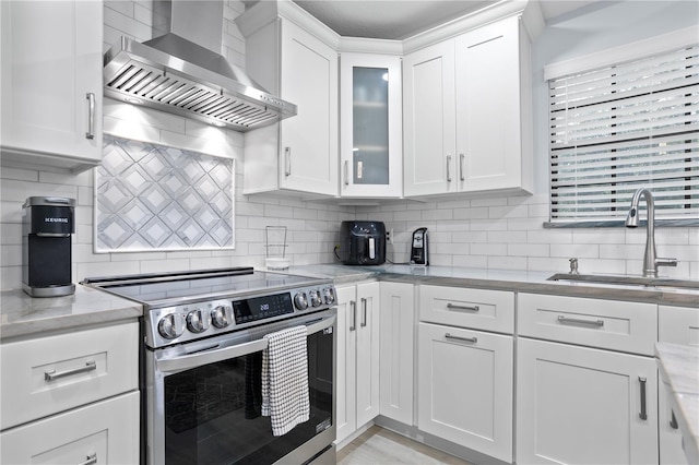 938 Southridge Trl, Altamonte Springs, FL 32714 - kitchen with electric stove, wall chimney range hood, a sink, and white cabinetry