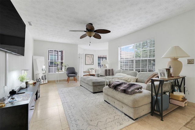 5323 Hansel Ave Unit E14, Orlando, FL 32809 - living area featuring a ceiling fan, light tile patterned floors, and a textured ceiling