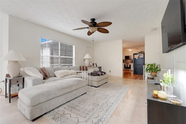 5323 Hansel Ave Unit E14, Orlando, FL 32809 - living room featuring a ceiling fan and light tile patterned flooring