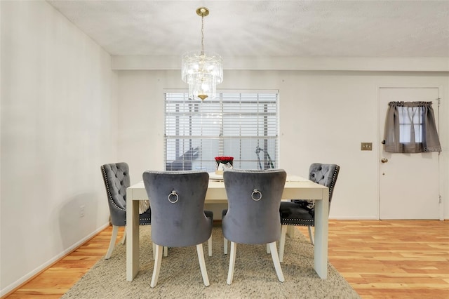 5323 Hansel Ave Unit E14, Orlando, FL 32809 - dining area with wood finished floors and a chandelier