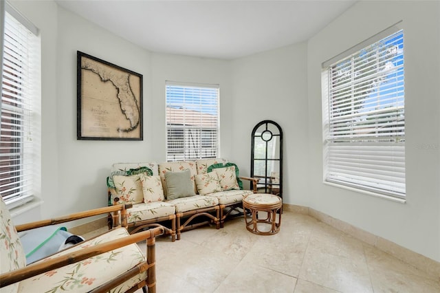 5323 Hansel Ave Unit E14, Orlando, FL 32809 - tiled living area featuring plenty of natural light and baseboards