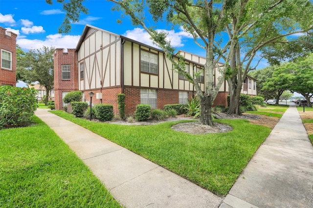 5323 Hansel Ave Unit E14, Orlando, FL 32809 - view of side of property with brick siding and a yard