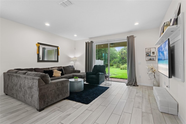 2339 Jernigan Loop, Kissimmee, FL 34746 - living room featuring light wood finished floors, recessed lighting, and baseboards