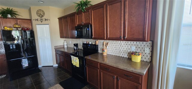 7620 Tangle Rush Dr, Gibsonton, FL 33534 - kitchen featuring black appliances, decorative backsplash, dark countertops, and dark tile patterned floors