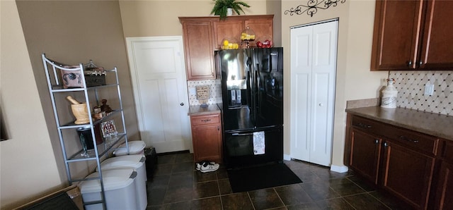 7620 Tangle Rush Dr, Gibsonton, FL 33534 - kitchen with black refrigerator with ice dispenser, decorative backsplash, and dark tile patterned flooring