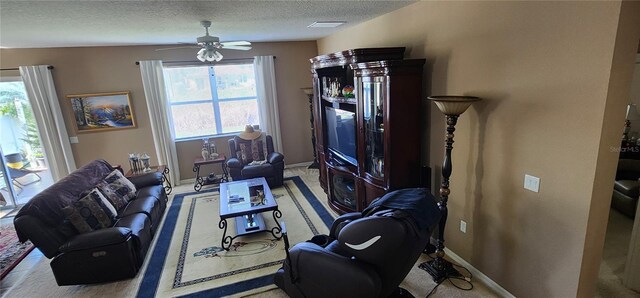 7620 Tangle Rush Dr, Gibsonton, FL 33534 - carpeted living room featuring ceiling fan, a textured ceiling, and baseboards