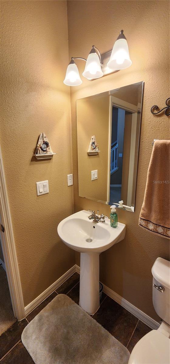 7620 Tangle Rush Dr, Gibsonton, FL 33534 - bathroom with toilet, baseboards, and tile patterned floors