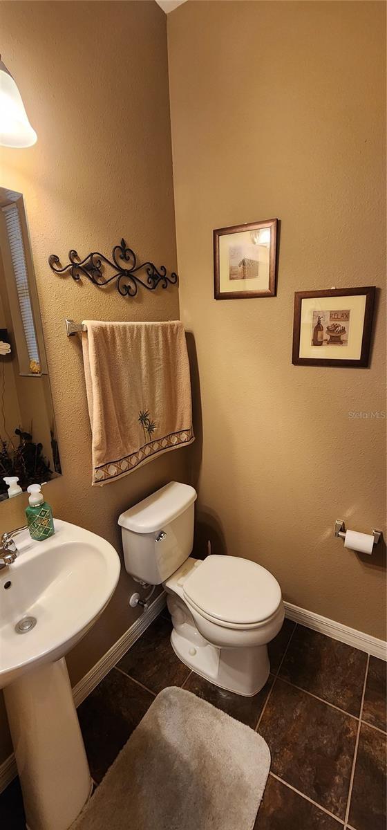 7620 Tangle Rush Dr, Gibsonton, FL 33534 - bathroom with toilet, tile patterned flooring, and baseboards
