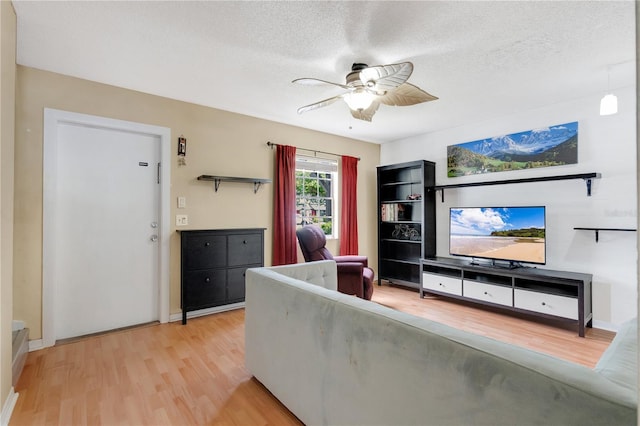 5662 Royal Pine Blvd Unit 24, Orlando, FL 32807 - living room with ceiling fan, light wood-style floors, a textured ceiling, and baseboards