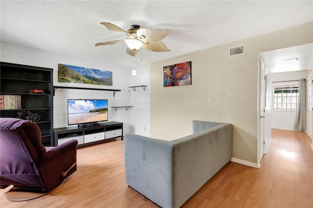 5662 Royal Pine Blvd Unit 24, Orlando, FL 32807 - living room featuring light wood finished floors, ceiling fan, and baseboards