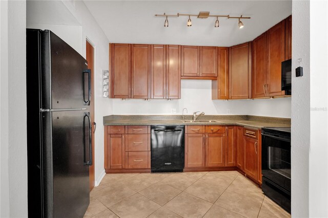 5662 Royal Pine Blvd Unit 24, Orlando, FL 32807 - kitchen with black appliances, a sink, brown cabinetry, light tile patterned flooring, and dark countertops