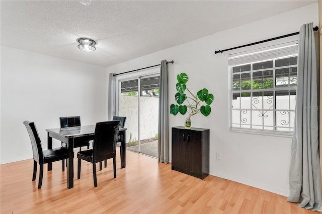 5662 Royal Pine Blvd Unit 24, Orlando, FL 32807 - dining area with light wood-style floors and a textured ceiling