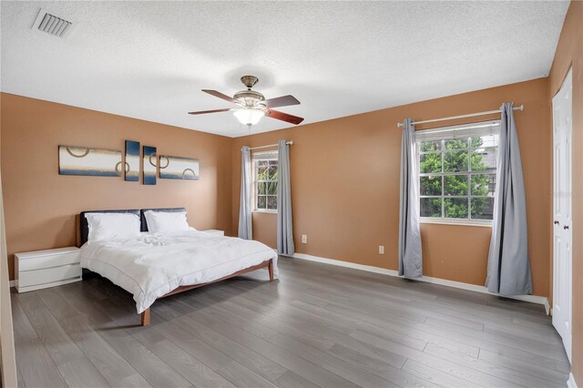 5662 Royal Pine Blvd Unit 24, Orlando, FL 32807 - bedroom with a textured ceiling, baseboards, wood finished floors, and a ceiling fan