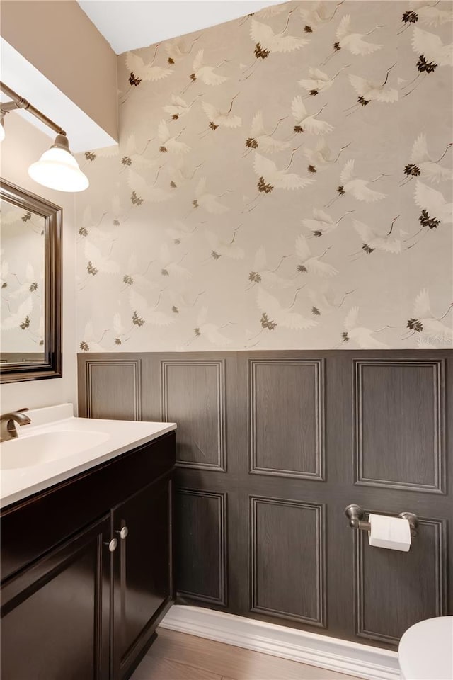 5662 Royal Pine Blvd Unit 24, Orlando, FL 32807 - bathroom with wallpapered walls, vanity, toilet, and wood finished floors