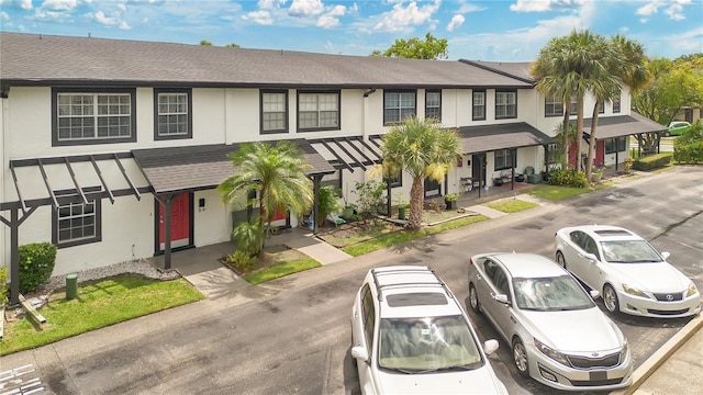 5662 Royal Pine Blvd Unit 24, Orlando, FL 32807 - view of property with a shingled roof and stucco siding