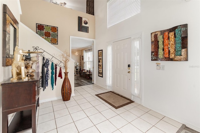 16012 Lanesboro Ct, Clermont, FL 34711 - foyer with a high ceiling, stairs, and light tile patterned flooring