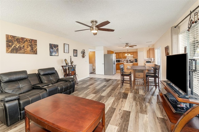 16012 Lanesboro Ct, Clermont, FL 34711 - living area with ceiling fan, light wood finished floors, and a textured ceiling