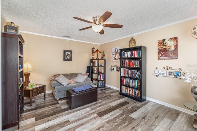 16012 Lanesboro Ct, Clermont, FL 34711 - living area featuring ceiling fan, a textured ceiling, wood finished floors, baseboards, and ornamental molding
